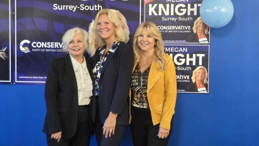 Megan Knight Campaign Launch Draws Strong Local Support in Surrey 4 Three women pose beside Megan Knight campaign signs at the Surrey campaign office.